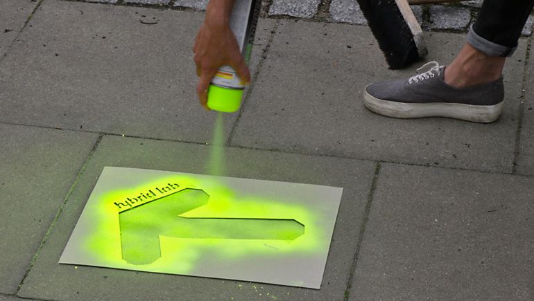 Green arrows marking the way to the new Hybrid Lab